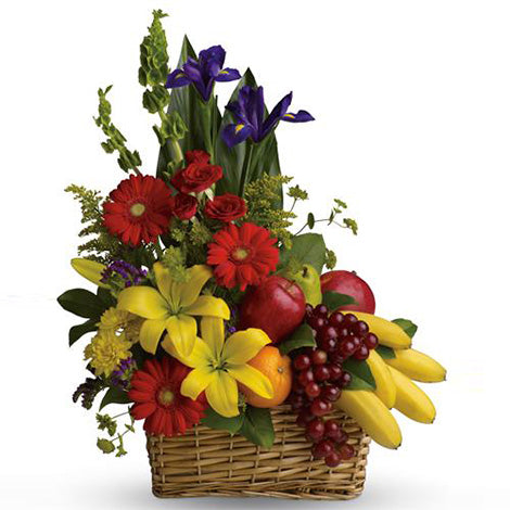 Selection of seasonal flowers and fruit presented in a gift basket